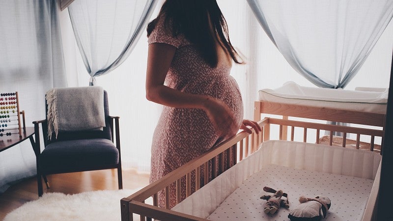 Mother looking at crib