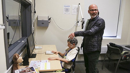 CTN scientist administering EEG on a child